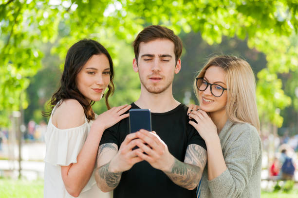 istock Group of Smiling friends Taking Selfie Outdoors at park 697798134