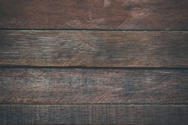 istock Vintage surface wood table and rustic grain texture background. Close up of dark rustic wall made of old wood table planks texture. Rustic brown wood table texture background template for your design. 697801234