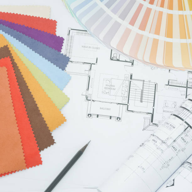 istock Interor designer working table with drawing, sample fabric and color palette 697801888