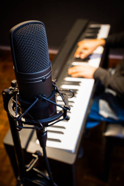istock condenser microphone on musician hands playing piano background 697801992