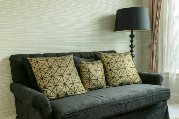 istock elegant living room interior with golden pattern pillows on black velvet sofa 697805336