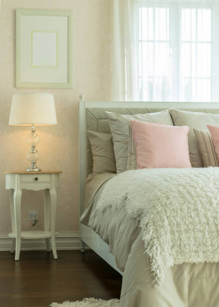 istock luxury bedroom interior with pink pillows and reading lamp on bedside table 697805858