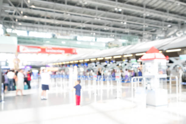 istock Blurred image of passengers wait in a queue for check-in in an airport. 697815426
