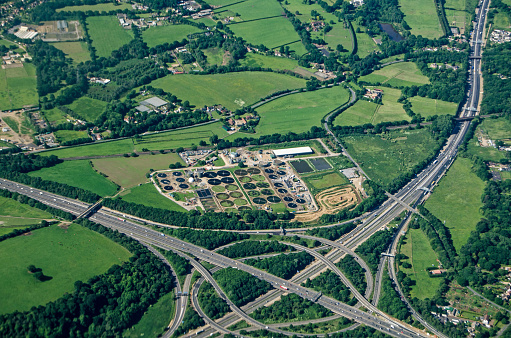 View from a plane of the Thorpe Interchange junction between the M25 and M3 motorways in South West London.  A Thames Water sewage treatment plant is right next to the busy roads in Virginia Water, Surrey.
