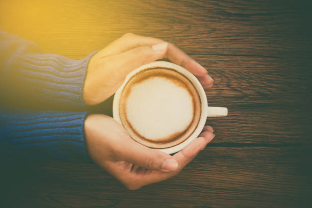 istock Young woman hand holding cup 697819556