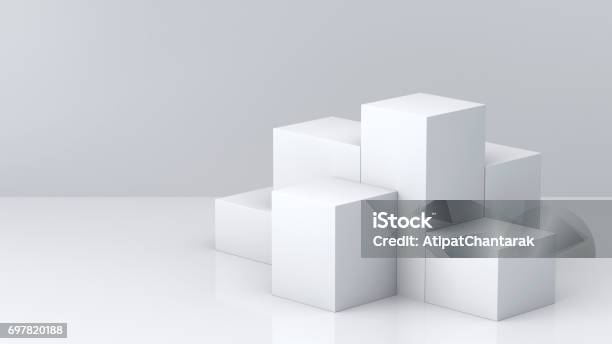 White Cube Boxes With White Blank Wall Background For Display 3d Rendering Stock Photo - Download Image Now