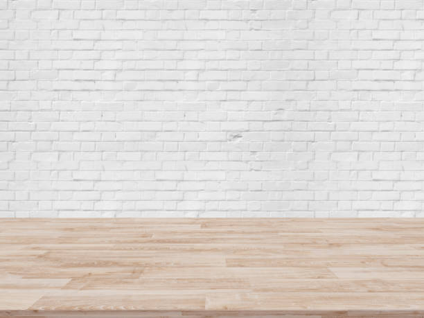 istock Table Top And Blur white brick wall Of The Background 697824038