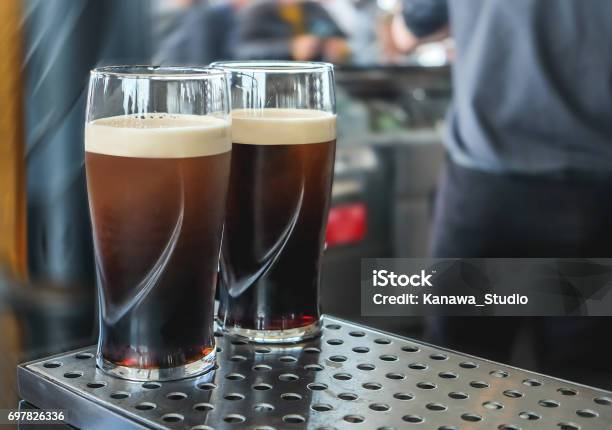 Two Pint Of Dark Beer On The Bar Stock Photo - Download Image Now - Pint Glass, Dublin - Republic of Ireland, Stout Ale