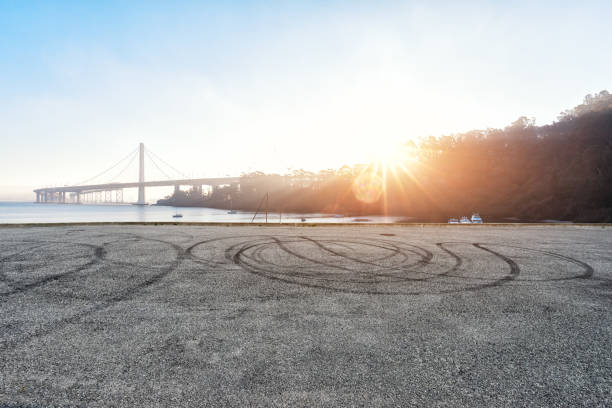 istock empty road near suspension bridge with sunbeam 697826390