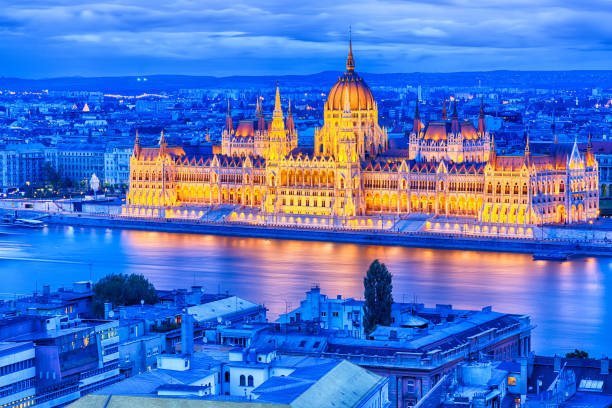 istock Parliament and riverside in Budapest Hungary during blue hour sunset 697828138