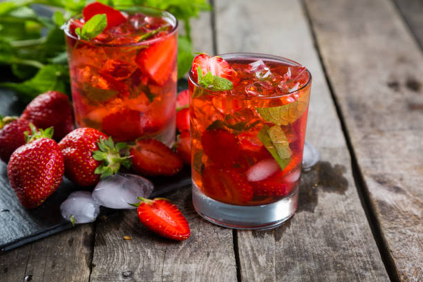 istock Strawberry mojito and ingredients on rustic background 697837598