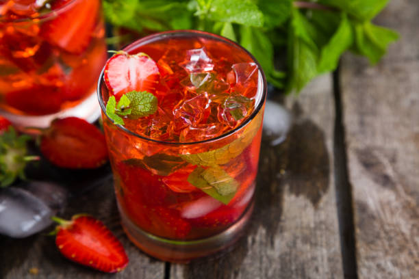 istock Strawberry mojito and ingredients on rustic background 697837660