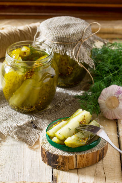 istock Marinated cucumbers gherkins. Marinated pickles with mustard and garlic on the kitchen table. 697837858
