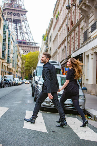 istock Well Dressed Couple in Paris Crossing the Road 697838324