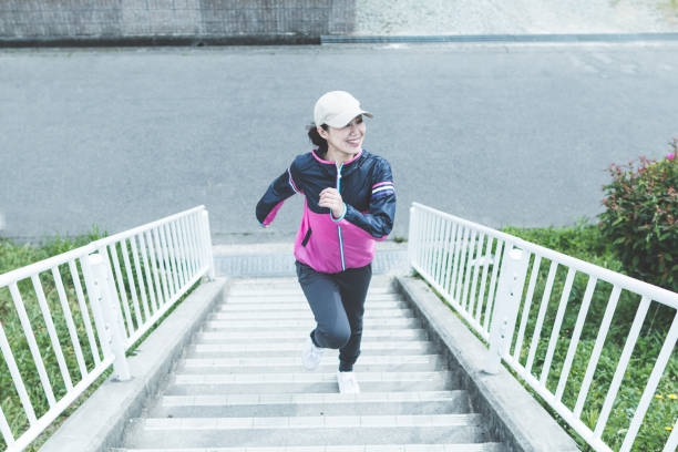 istock Woman running the stairs 697838564