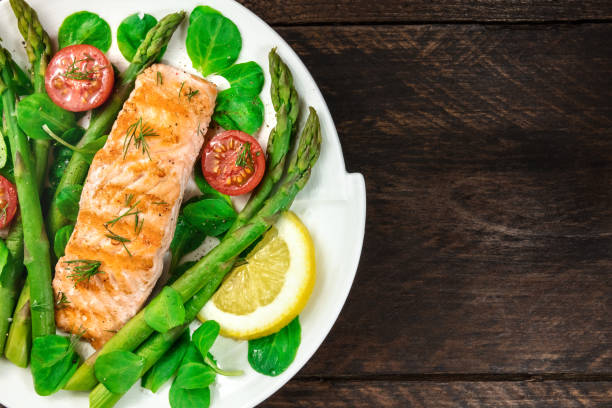 istock Grilled salmon with asparagus and green salad 697842838