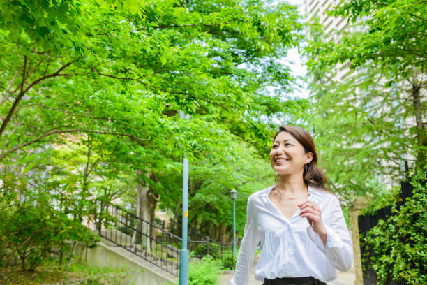 istock woman walking in the fresh green 697850046