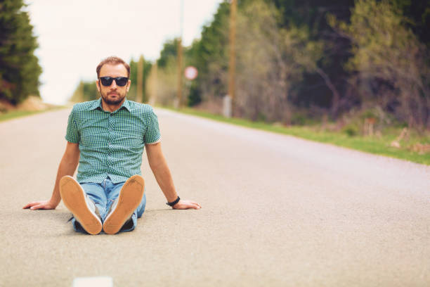 istock Modern man sitting on the road. 697850166