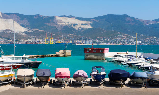 Boats parking on the black sea Novorossiysk, Russia - august 22, 2015: Boats parking - Different small boats on the mooring. small houseboats stock pictures, royalty-free photos & images