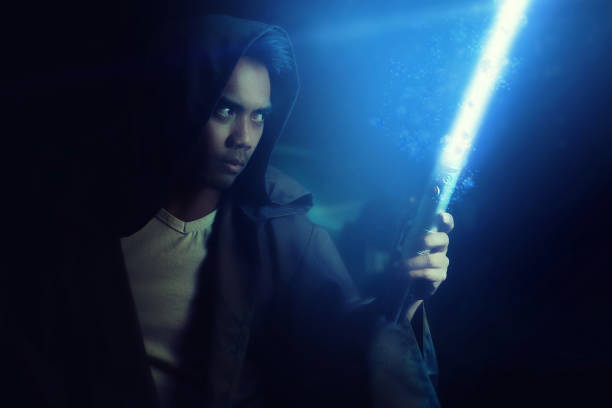 istock Young warrior holding a lightsaber 697850490