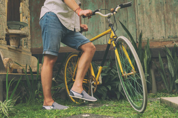 istock Young attractive man enjoying outdoors with old bicycle. 697850544