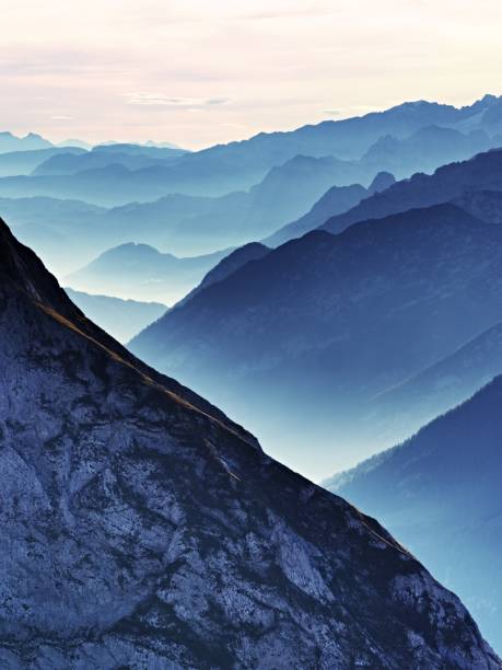 Aerial photo of the Bavarian Alps in the mist. High key mountain silhouettes.
