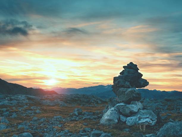 istock Stacked sharp stones at trail. Heavy white  pebbles stack on rocky ground of mountain 697854024