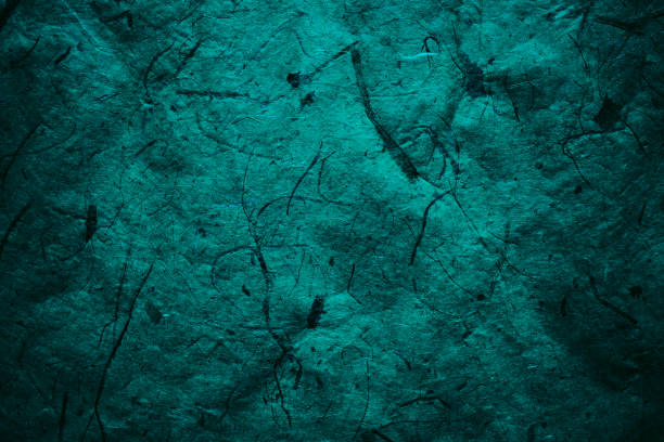 istock Abstract turquoise texture and background for designers. Vintage paper background. Rough turquoise texture of recycled paper. Closeup view of abstract turquoise texture. Vintage blue paper. 697860350