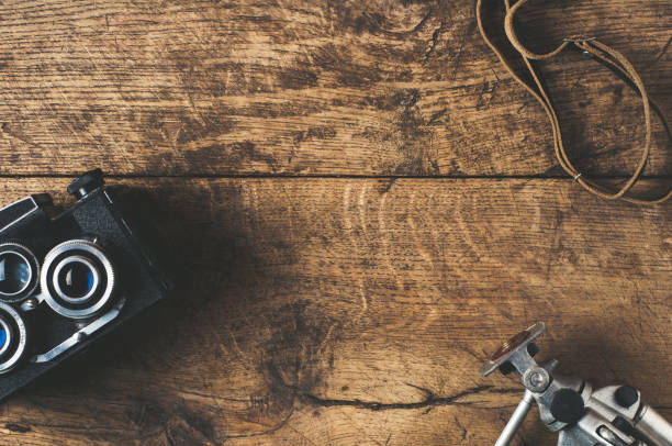 istock Retro camera and equpment on a wooden background 697863036