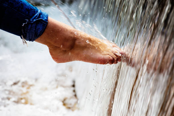 Human foot touches natural water