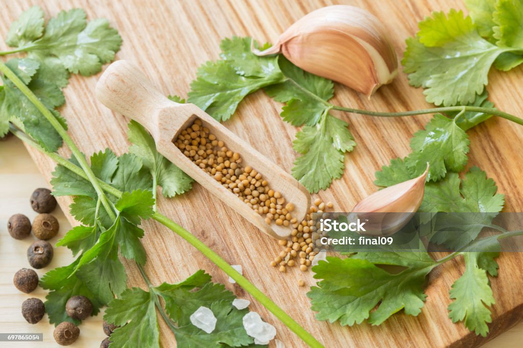 Cooking Additives. Parsley, garlic, pepper Cooking Additives. Parsley, garlic, pepper pots, mustard seeds. Allspice Stock Photo
