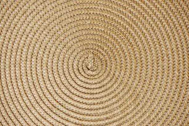 Photo of Round woven straw background with the center in the middle of the image