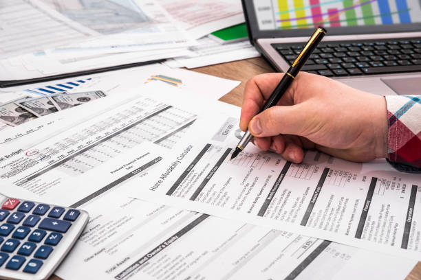 istock businessman making report, calculating or checking balance. 697868002