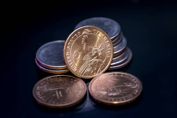 istock us coin dollar isolated on black background. 697875048