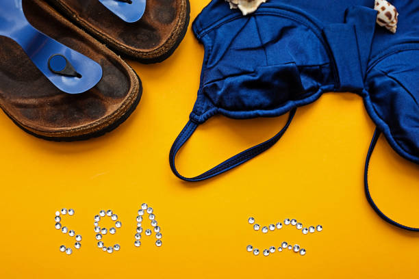 istock Blue swimsuit and beach slippers 697878404