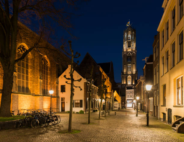Utrecht: Buurkerkhof at night with the Dom (church), bikes and  monumental houses.