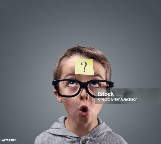 Confused Boy Thinking With Question Mark Stock Photo - Download Image Now - Child, Question Mark, Asking