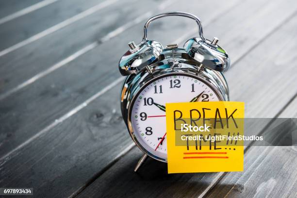 Close Up Of Alarm Clock With Message Break Time On Wooden Tabletop Stock Photo - Download Image Now