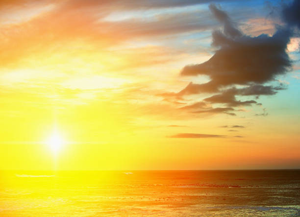 istock Glorious golden sunset seen from across the sea 697899716