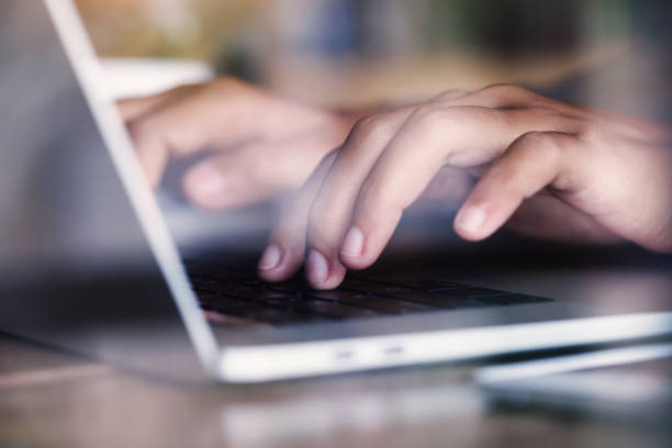 istock close-up finger typing on laptop keyboard see through glass 697901342