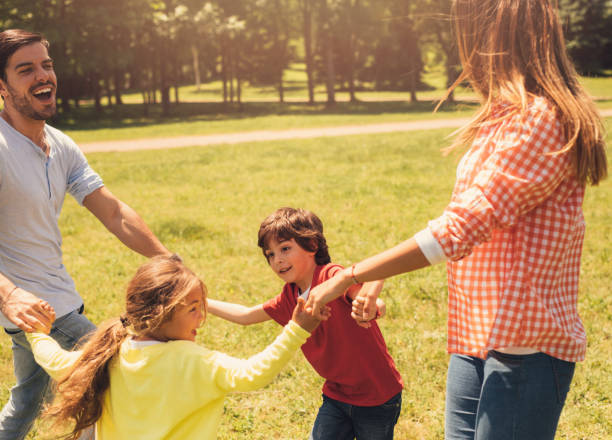 istock Happy family spinning in the park 697902146
