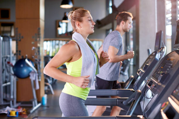 istock Healthy Woman Running on Treadmill 697902732