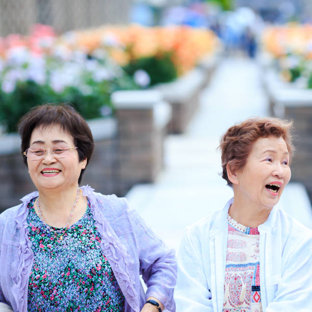 istock Flower field and elderly women 697903138