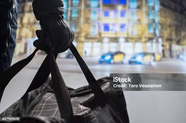 Close Up Of Terrorist Holding Black Bomb Bag In Hand Suicide Bomber Planning Dangerous Explosion In City Center At Night Traffic Cars And Buildings In Background Terrorism And Security Concept Stock Photo - Download Image Now