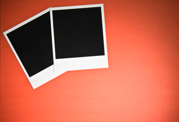 istock two blank instant photo frames on red background with copy space top view 697910224