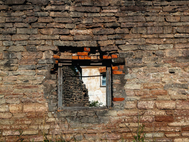 istock Old brick wall of a ruined building with a window 697912554