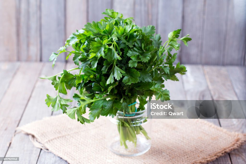 Fresh green parsley on the wooden table Parsley Stock Photo