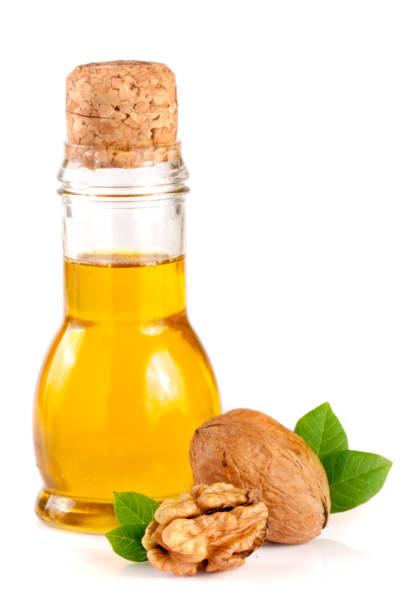 istock Walnut oil with nuts isolated on a white background 697927054