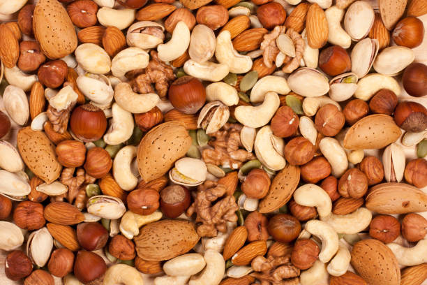 istock Mix of different nuts as background close-up 697927382