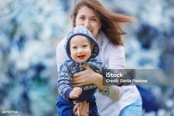 Mother Shows The Child Holding It In Her Arms Stock Photo - Download Image Now - Animal Behavior, Approaching, Apricot